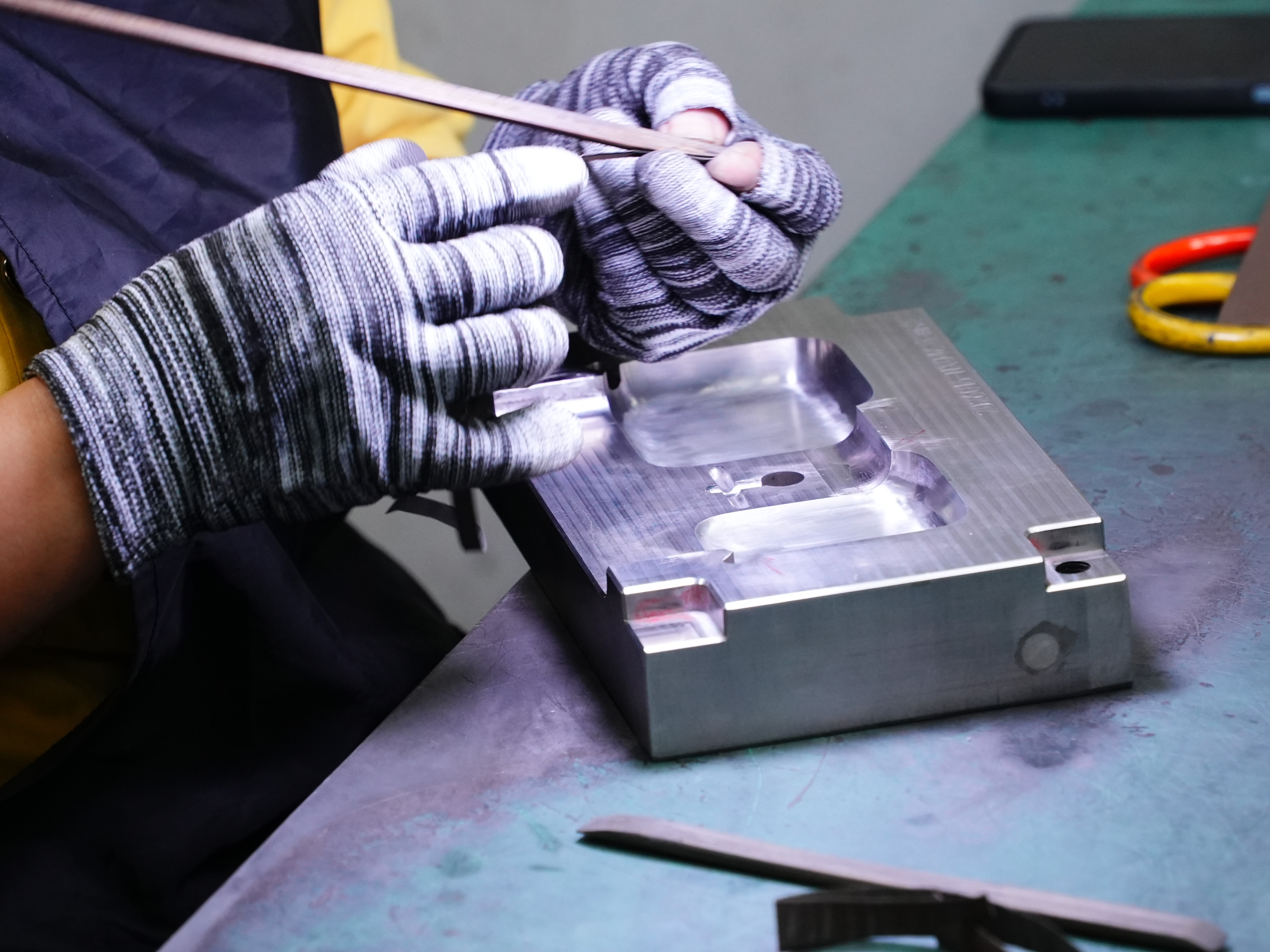 Custom enclosure tooling pcba development Guangdong, worker polishing plastic housing injection mold for electronic circuit board assembly